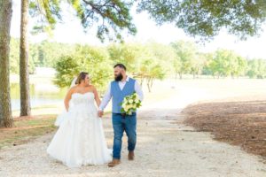 Wedding venue outdoor ceremony site featuring bride and groom near waterfront views