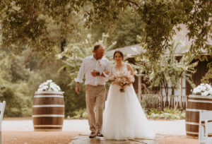 Houston bride and groom at their outdoor wedding ceremony by the lake