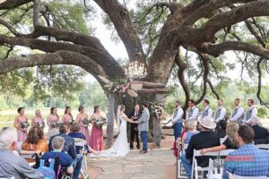 Outdoor wedding ceremony at a Houston Texas wedding venue with the wedding party, bridesmaids and groomsmen