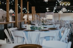 Elegant affordable wedding reception near Houston with tables, chairs, elegant lighting and wedding decor