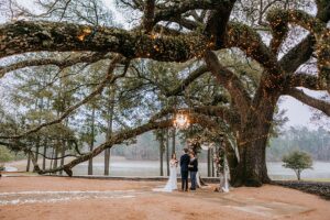 Houston Texas wedding venue bride and groom kiss at their elegant outdoor wedding ceremony. 