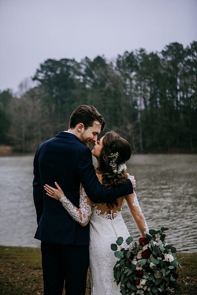 wedding couple kisses in front of pond