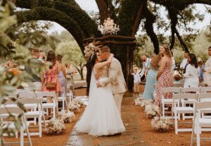 Houston Texas wedding venue bride and groom kiss at their elegant outdoor wedding ceremony. 