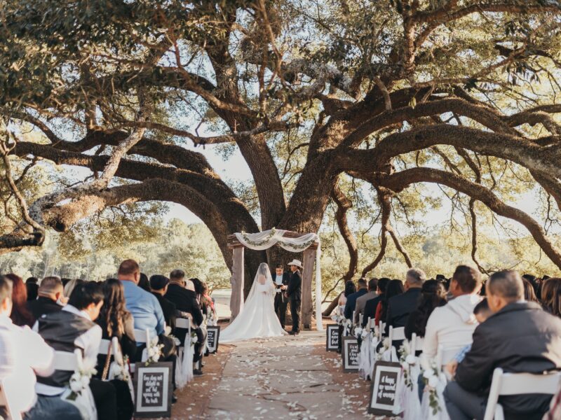 Houston Texas wedding venue bride and groom exchange vows at their elegant outdoor wedding ceremony.