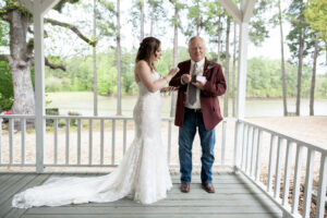 Top 100 Houston Sites for Engagement Photos 8 Bride and father of the bride first look at lakefront wedding venue near Houston
