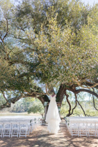 Wedding planner organizing décor and floral arrangements at a Texas ranch wedding venue.