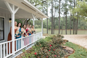 Bride and bridesmaids getting ready while the wedding planner manages the day‑of schedule.