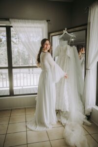 Bride getting ready to put on her designer wedding dress before she walks down the aisle at our Houston wedding venue