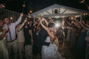 Sparkler wedding exit with bride & groom being celebrate by wedding guests at a Houston wedding venue