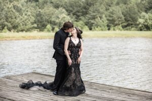 Engaged couple celebrating engagement while planning their wedding website and guest list online