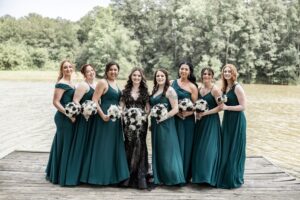 Bridesmaids pose for wedding day photos on our pier at our all inclusive lakefront wedding venue near Houston. 