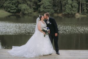 Planning The Perfect Houston Wedding Weekend 10 Bride and groom taking real wedding day photos by the lake at a rustic wedding venue in Montgomery Texas near Houston