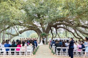 Planning The Perfect Houston Wedding Weekend 7 Wedding guests wait for the bride and groom at an outdoor wedding ceremony near Houston in Montgomery Texas